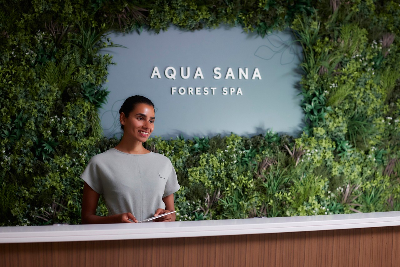 Staff member stood at the reception of Aqua Sana Forest Spa.